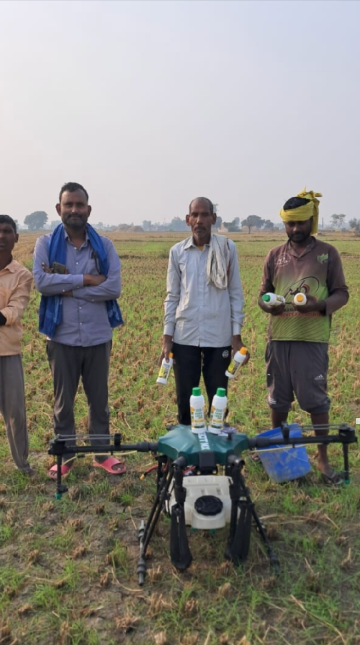 Naya Rasta member farmers in the field with a crop-spraying drone